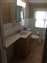 Granite Banjo Sink & Counter Top, 6" ceramic Tile Floor and American Standard White Toilet